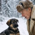 The forest ranger spotted a small puppy deep in the woods, sitting on an old sack, as if he were guarding it. What he saw inside made him pale and nearly faint with fear…